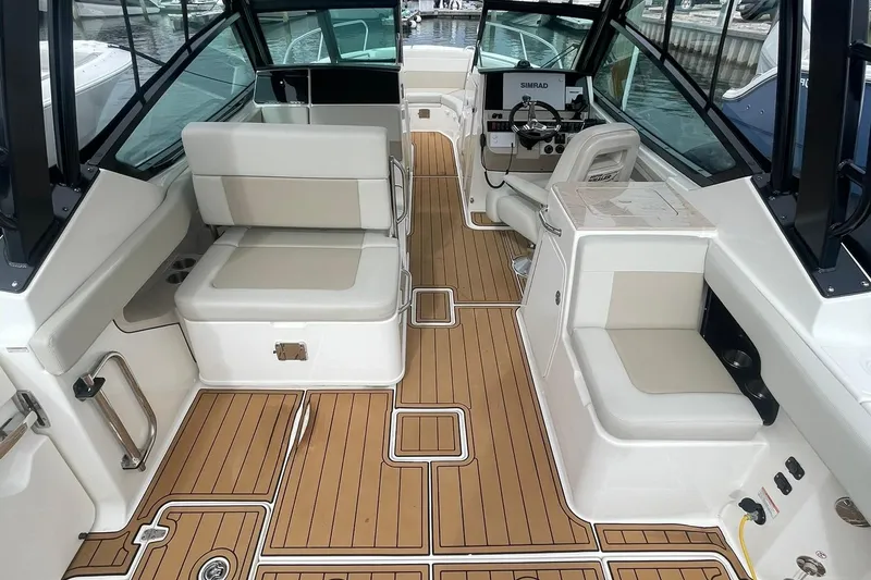 Slide: The Image of 2023 Boston Whaler 280 Vantage interior with seating and helm, featuring SeaDek synthetic decking - 3