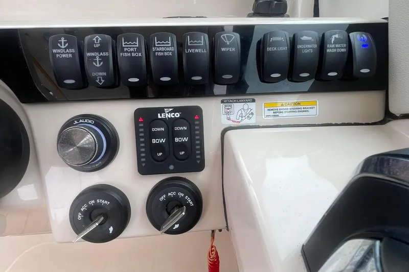 Slide: The Image of Control panel of 2023 Boston Whaler 280 Vantage boat with various switches and controls. - 42