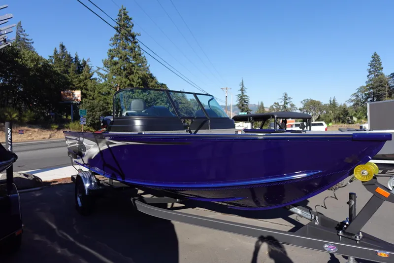 The Image of 2025 G3 AV19SF boat in vibrant blue on a trailer, parked outdoors. - 0