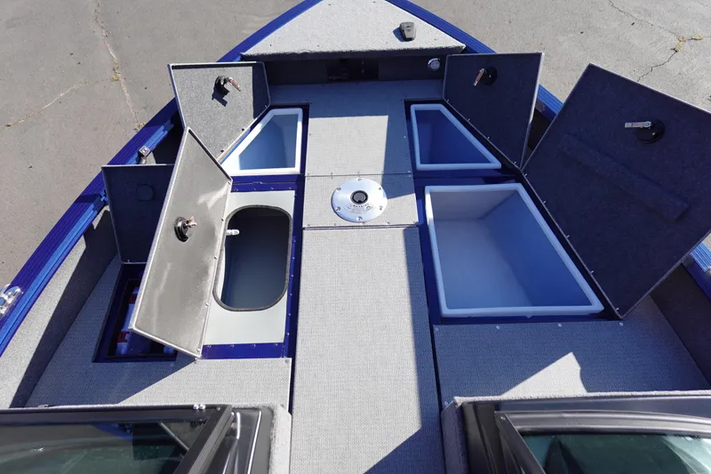 Slide: The Image of 2025 G3 AV19SF boat interior with open storage compartments and carpeted deck. - 19