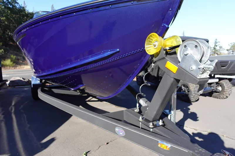 Slide: The Image of 2025 G3 AV19SF boat on trailer, featuring a sleek blue hull design. - 2