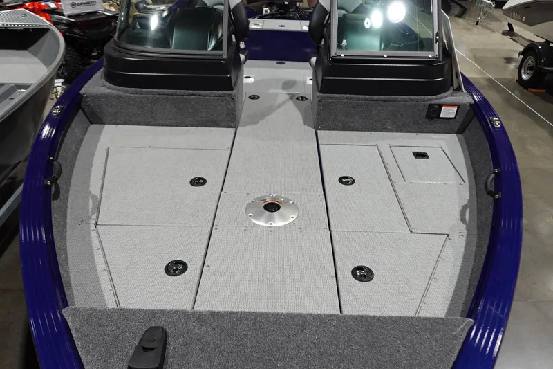 Slide: The Image of 2025 G3 AV19SF boat interior with gray carpeted deck and storage compartments. - 9