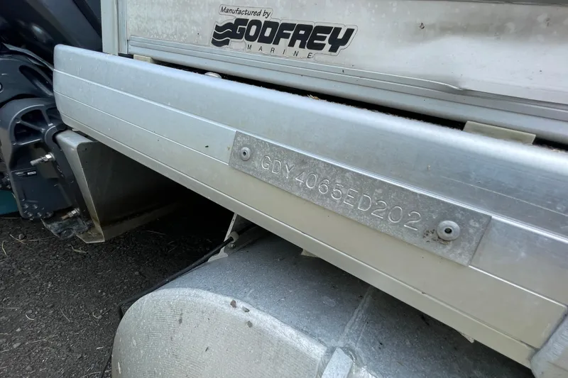 Slide: The Image of 2002 Godfrey Aqua Patio 2424DF boat with visible serial number plate. - 8