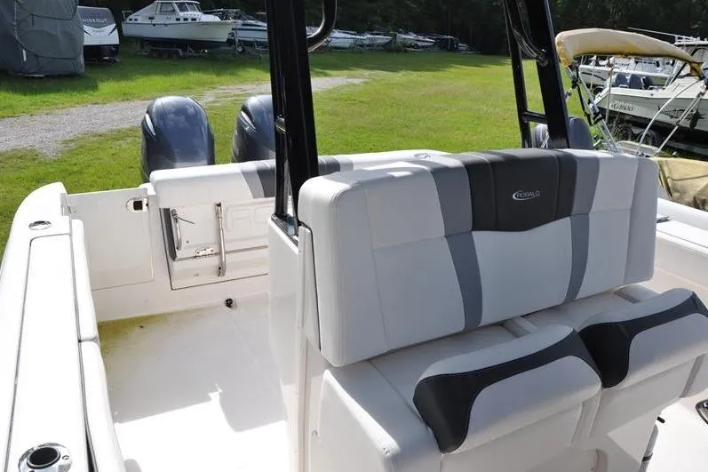 Slide: The Image of 2023 Robalo R272 Center Console boat interior with dual seats and twin engines. - 17