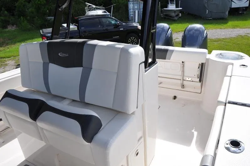 Slide: The Image of 2023 Robalo R272 Center Console boat interior with seating and dual engines. - 18