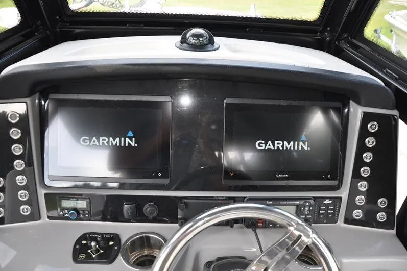 Slide: The Image of 2023 Robalo R272 Center Console dashboard with dual Garmin displays and steering wheel. - 20