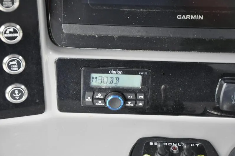 Slide: The Image of 2023 Robalo R272 Center Console dashboard with Clarion and Garmin electronics. - 22