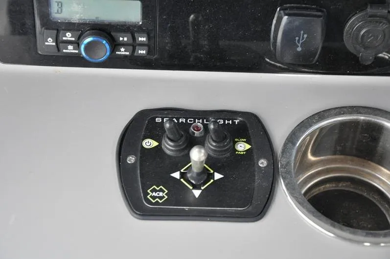 Slide: The Image of Control panel of 2023 Robalo R272 Center Console boat with searchlight controls. - 23