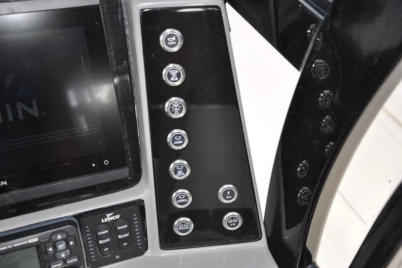 Slide: The Image of 2023 Robalo R272 Center Console dashboard with control buttons and display screen. - 25