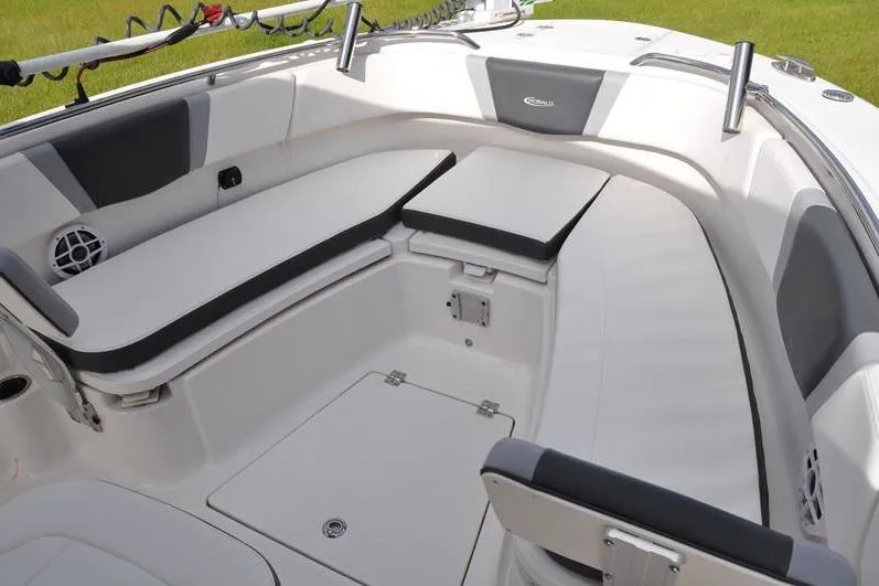 Slide: The Image of 2023 Robalo R272 Center Console boat interior with cushioned seating and storage. - 30