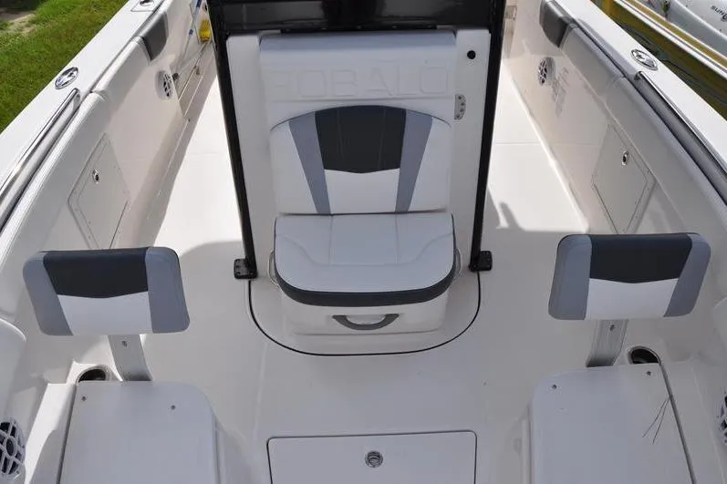 Slide: The Image of 2023 Robalo R272 Center Console boat interior with cushioned seating and storage. - 32