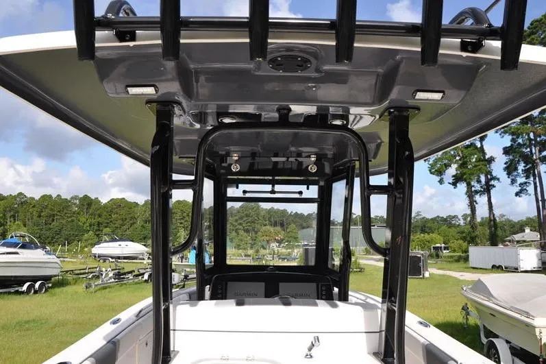 Slide: The Image of 2023 Robalo R272 Center Console boat with T-top, parked outdoors. - 8