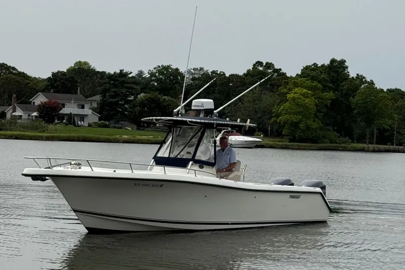 The Image of 2008 Pursuit C 280 Center Console boat on calm water near shoreline. - 0