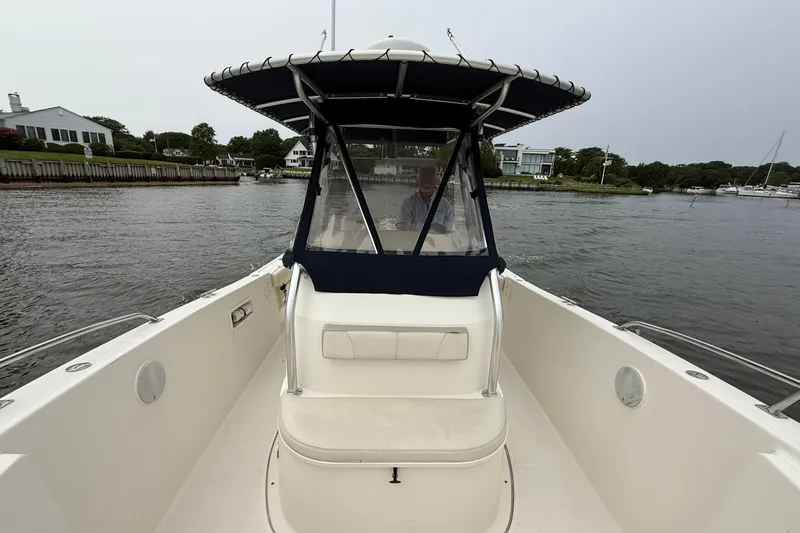 Slide: The Image of 2008 Pursuit C 280 Center Console boat dashboard with steering wheel and navigation equipment. - 10