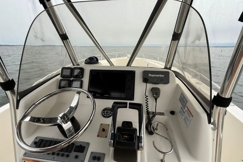 Slide: The Image of 2008 Pursuit C 280 Center Console helm with steering wheel, navigation, and control systems. - 11