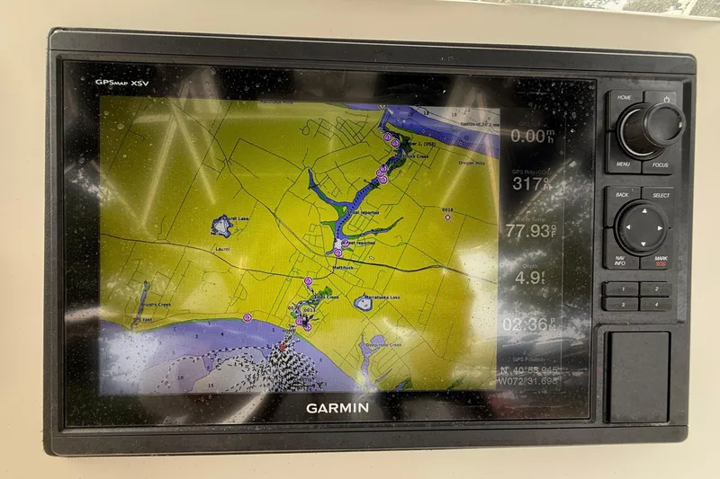 Slide: The Image of 2008 Pursuit C 280 Center Console dashboard with Garmin and Raymarine electronics. - 13