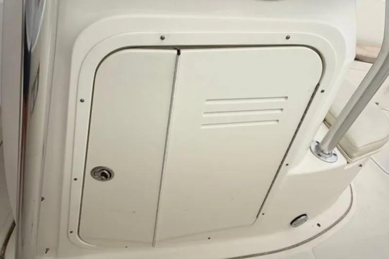 Slide: The Image of 2008 Pursuit C 280 Center Console boat storage compartment with latch and handle. - 17