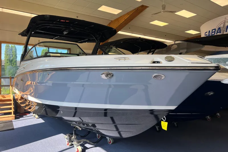 Slide: The Image of 2025 Sea Ray SLX 280 boat displayed indoors, showcasing sleek design and modern features. - 13