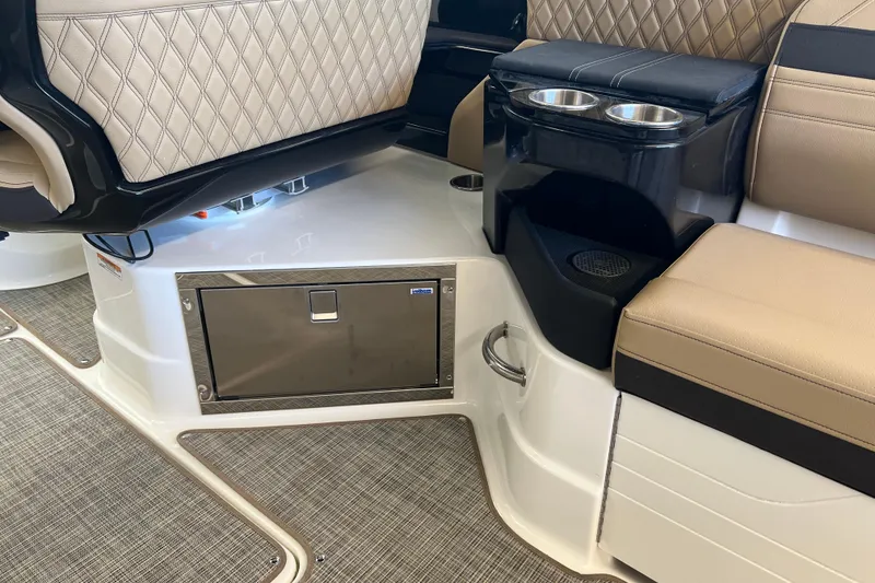 Slide: The Image of 2025 Sea Ray SLX 280 interior with luxurious seating and built-in cup holders. - 22