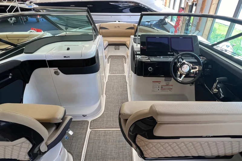 Slide: The Image of 2025 Sea Ray SLX 280 boat interior with modern dashboard and seating. - 24