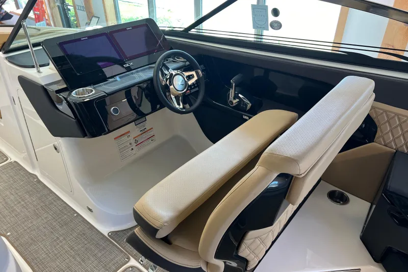 Slide: The Image of 2025 Sea Ray SLX 280 boat cockpit with modern steering and dual screens. - 25