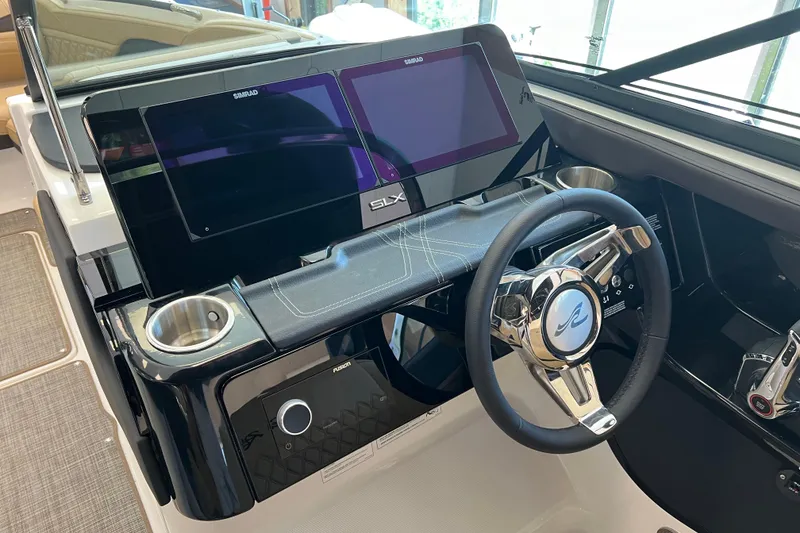 Slide: The Image of 2025 Sea Ray SLX 280 helm with modern controls and dual Simrad displays. - 26