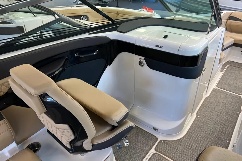 Slide: The Image of 2025 Sea Ray SLX 280 boat interior with beige seating and sleek design. - 28
