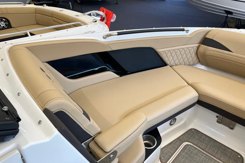Slide: The Image of 2025 Sea Ray SLX 280 boat interior with beige leather seating and modern design. - 31
