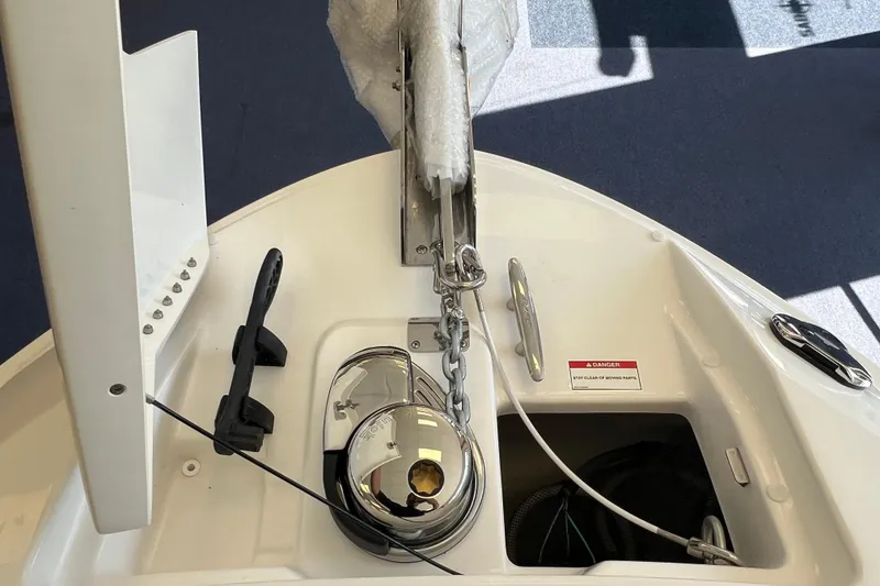 Slide: The Image of 2025 Sea Ray SLX 280 boat anchor system with chain and safety warning label. - 35