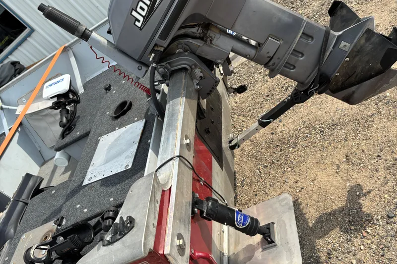 Slide: The Image of 1999 Lund SSV 14 Tiller boat with motor and Lowrance equipment on gravel surface. - 4