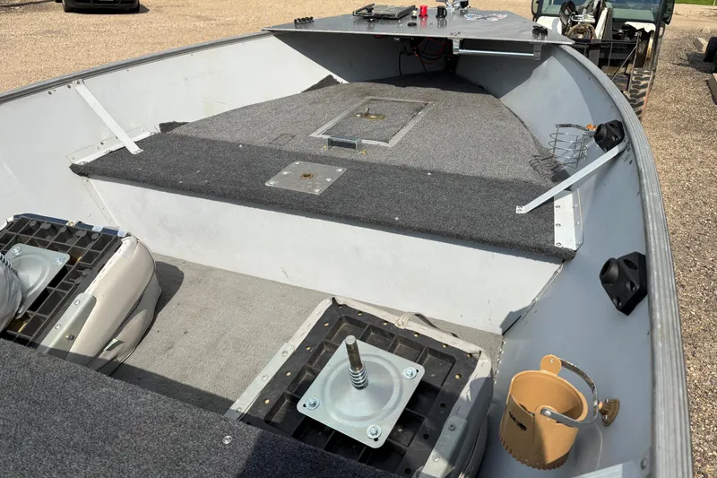 Slide: The Image of 1999 Lund SSV 14 Tiller boat interior with carpeted deck and seating mounts. - 9