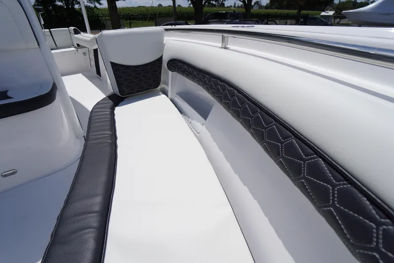 Slide: The Image of 2026 Tidewater 232 LXF boat interior with sleek white and black seating. - 11