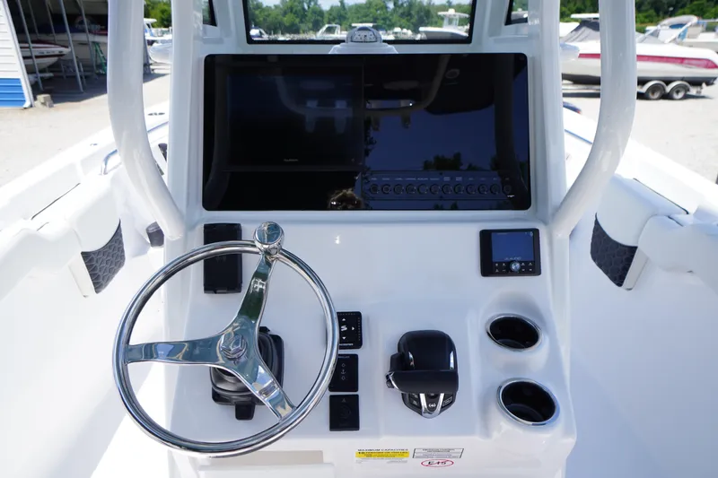 Slide: The Image of 2026 Tidewater 232 LXF boat dashboard with steering wheel and control panel. - 26