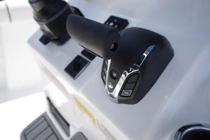 Slide: The Image of Close-up of 2026 Tidewater 232 LXF boat throttle controls. - 31