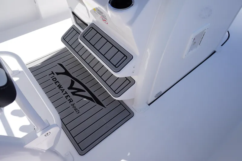 Slide: The Image of 2026 Tidewater 232 LXF boat interior with branded non-slip flooring and steps. - 33