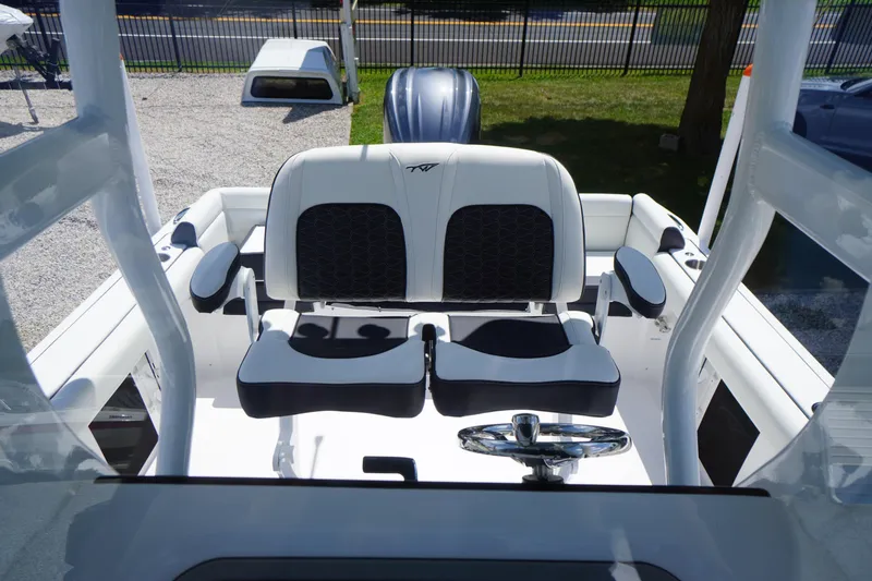 Slide: The Image of 2026 Tidewater 232 LXF boat interior with dual seats and steering wheel. - 37