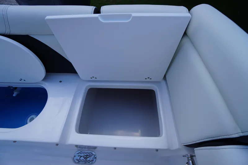 Slide: The Image of 2026 Tidewater 232 LXF boat storage compartment with open lid, showcasing interior space. - 53