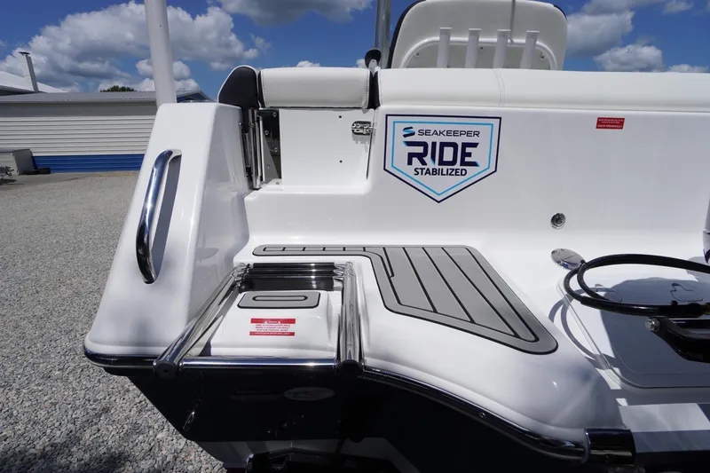 Slide: The Image of 2026 Tidewater 232 LXF boat with Seakeeper Ride stabilization system, docked under blue sky. - 73