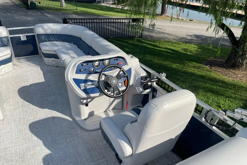 Slide: The Image of 2023 Nepallo 24QL Sport Toon pontoon boat interior with steering console and seating. - 5