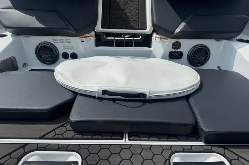 Slide: The Image of 2023 Scarab 255 ID boat interior with cushioned seating and speakers. - 14