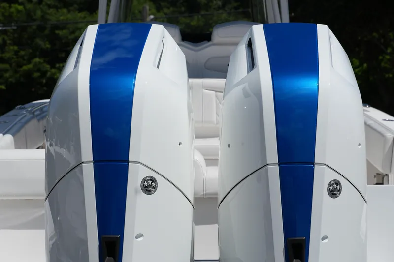 Slide: The Image of 2023 Fountain 34 Center Console boat engines with blue accents, rear view. - 11