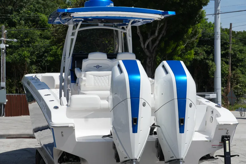 Slide: The Image of 2023 Fountain 34 Center Console boat with dual engines, sleek design, and blue accents. - 14