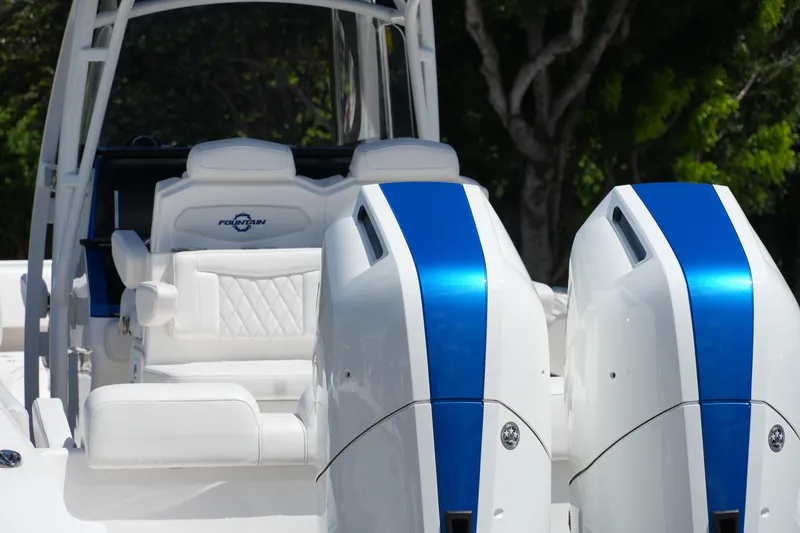 Slide: The Image of 2023 Fountain 34 Center Console boat with dual blue-striped engines. - 16