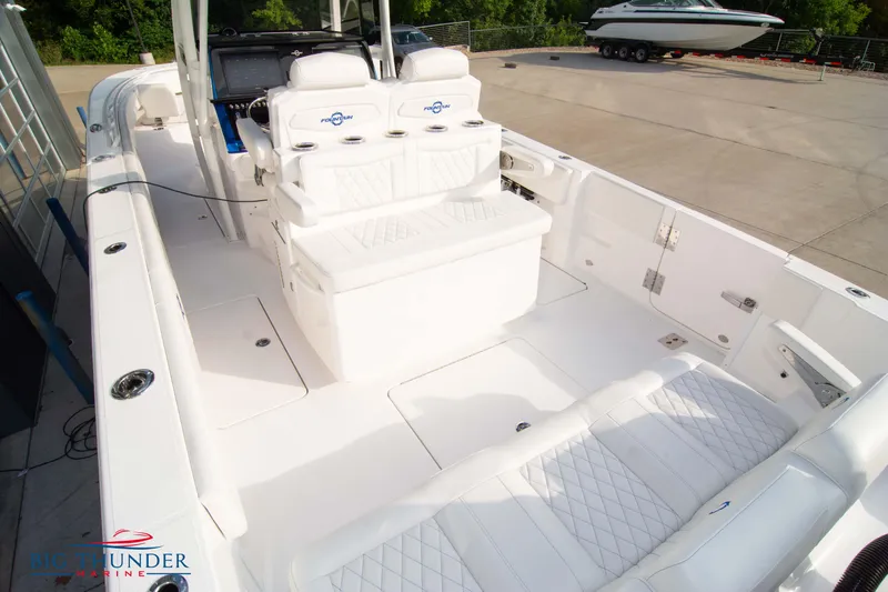 Slide: The Image of 2023 Fountain 34 CC boat interior with white seating and modern design. - 23