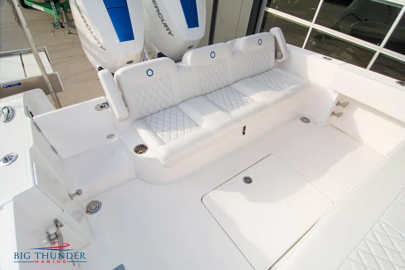 Slide: The Image of 2023 Fountain 34 CC boat with white seating and dual Mercury engines. - 24