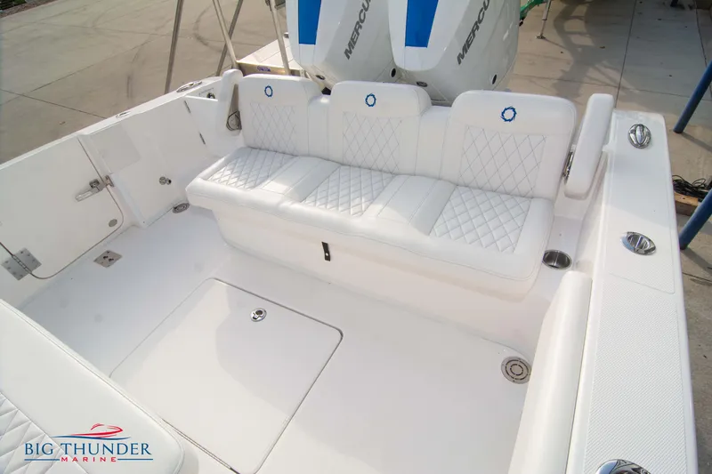 Slide: The Image of 2023 Fountain 34 CC boat interior with white cushioned seating and sleek design. - 25