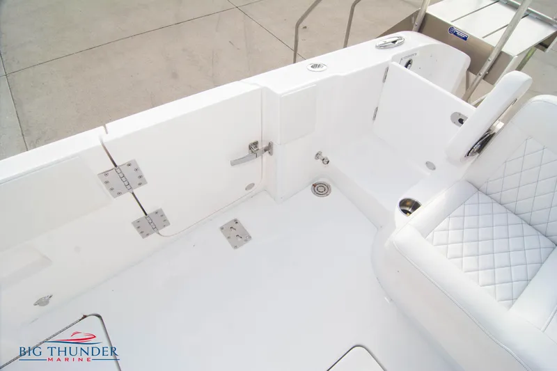 Slide: The Image of 2023 Fountain 34 CC boat interior with white seating and stainless steel fixtures. - 27