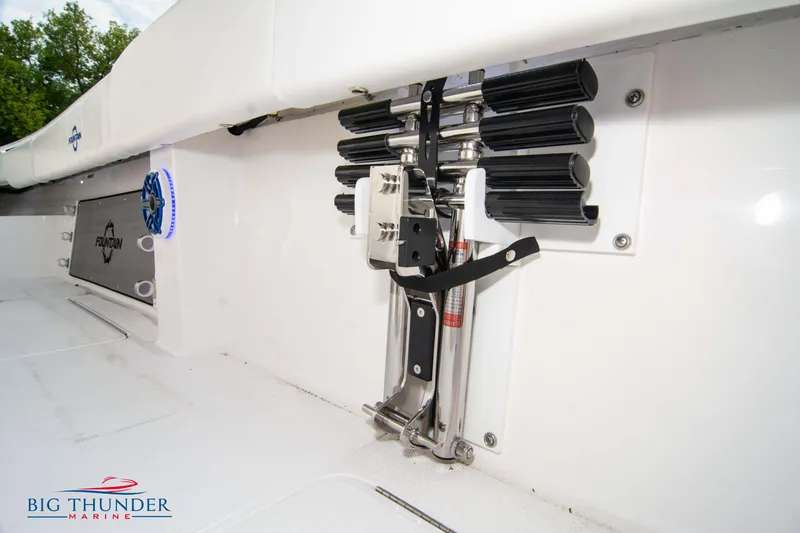 Slide: The Image of 2023 Fountain 34 CC boat interior with rod holders and branded logo. - 29