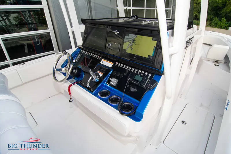 Slide: The Image of 2023 Fountain 34 CC boat cockpit with advanced navigation system and controls. - 45