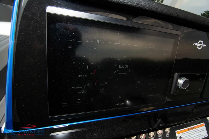 Slide: The Image of 2023 Fountain 34 CC boat dashboard with Garmin display and controls. - 47